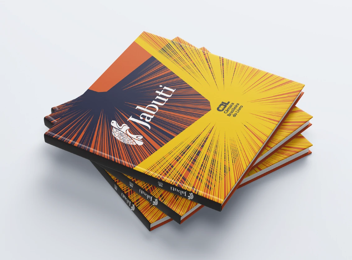 Pilha de catálogos do Prêmio Jabuti 2024 — capa em amarelo e laranja